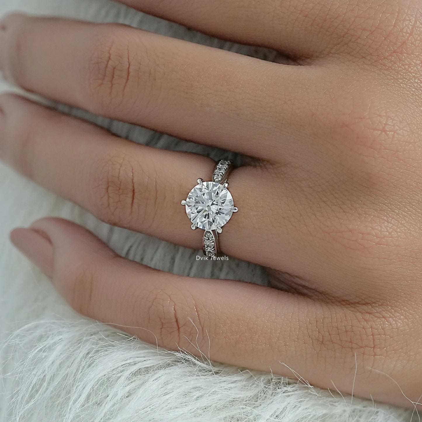 Round solitaire pave engagement ring with a striking emerald cut center.