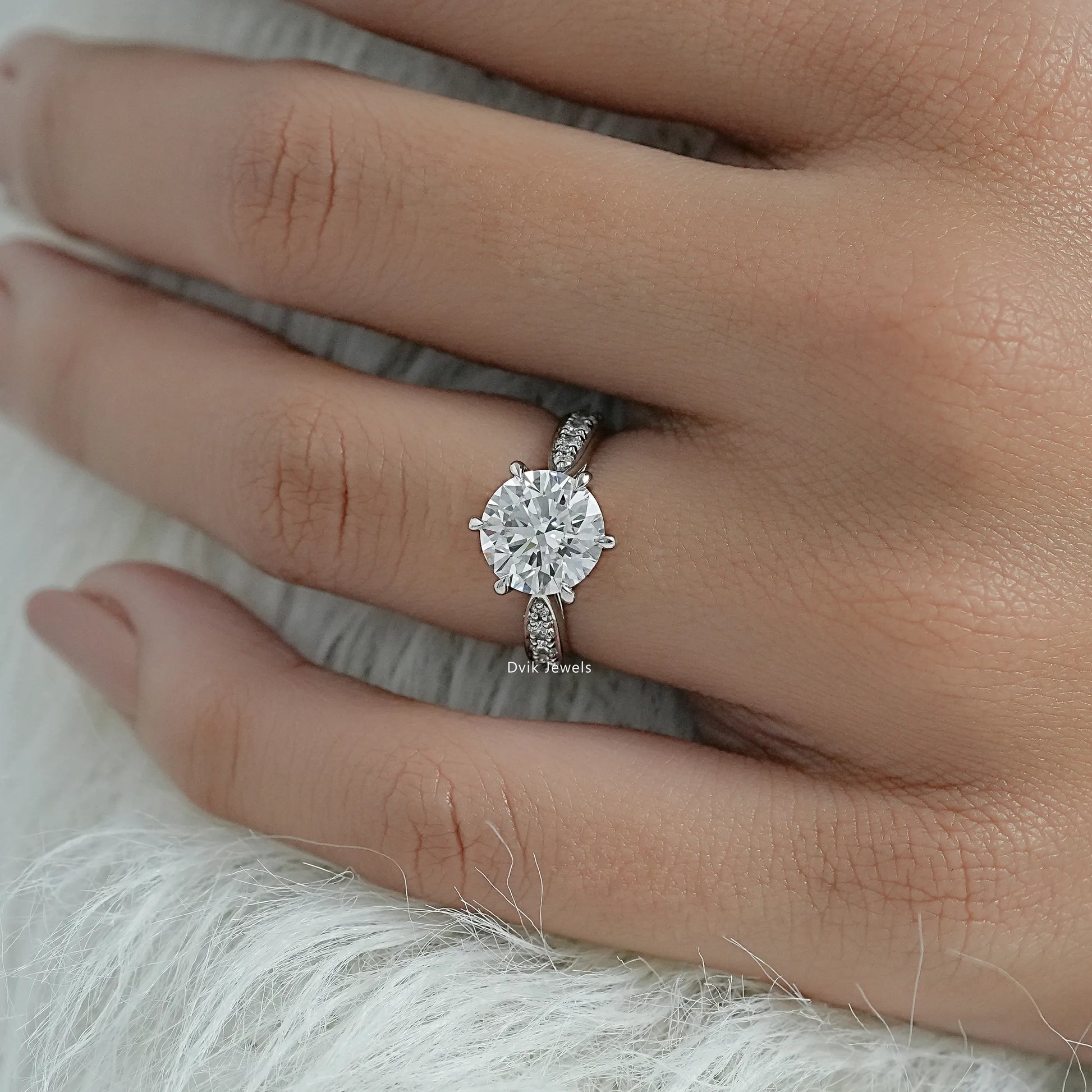 Round solitaire pave engagement ring with a striking emerald cut center.