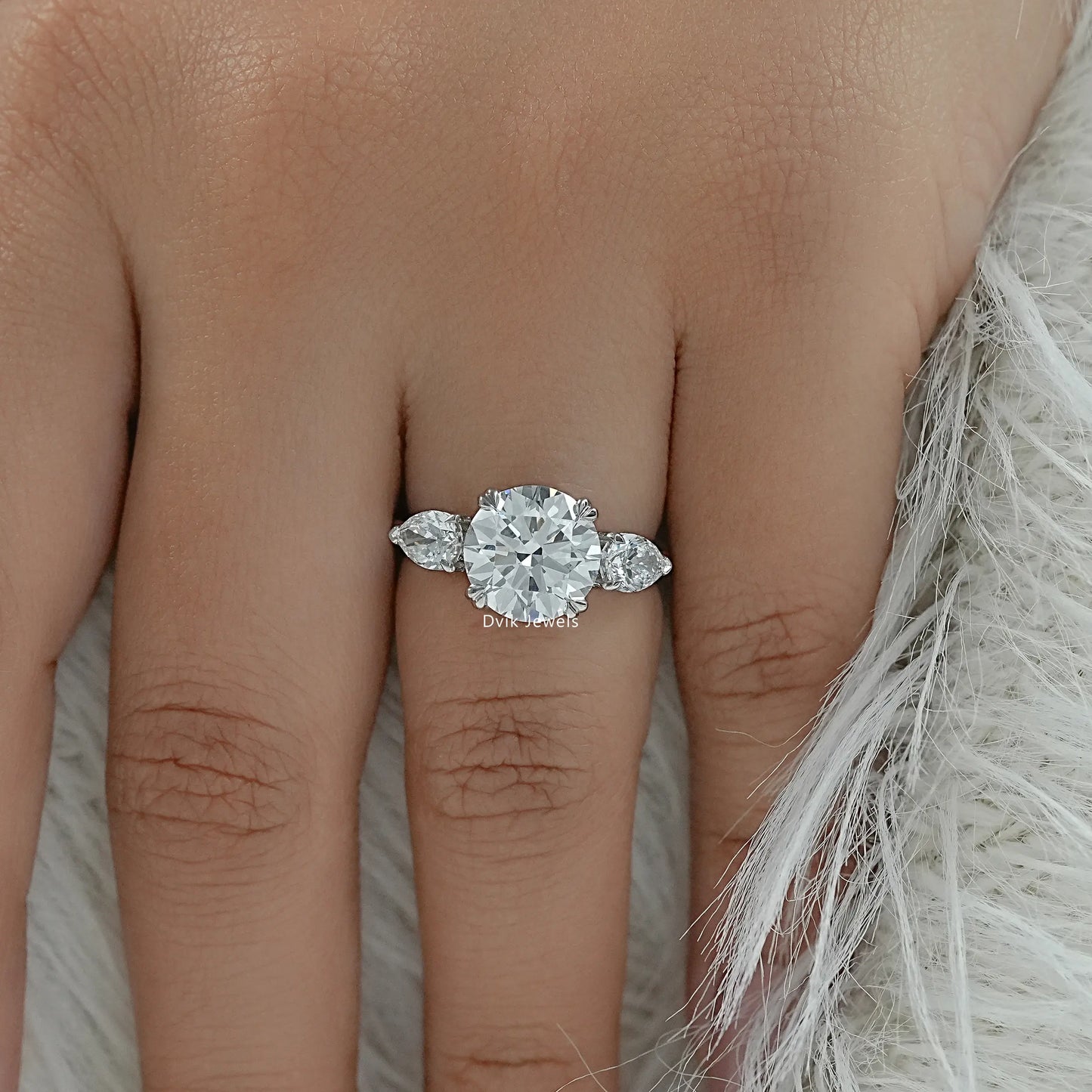 Round engagement ring with side stones on finger top view