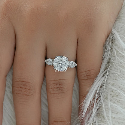 Round engagement ring with side stones on finger top view