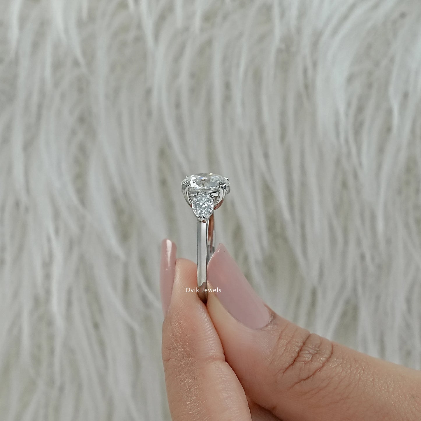 Lab grown diamond three stone ring round three stone engagement ring close up