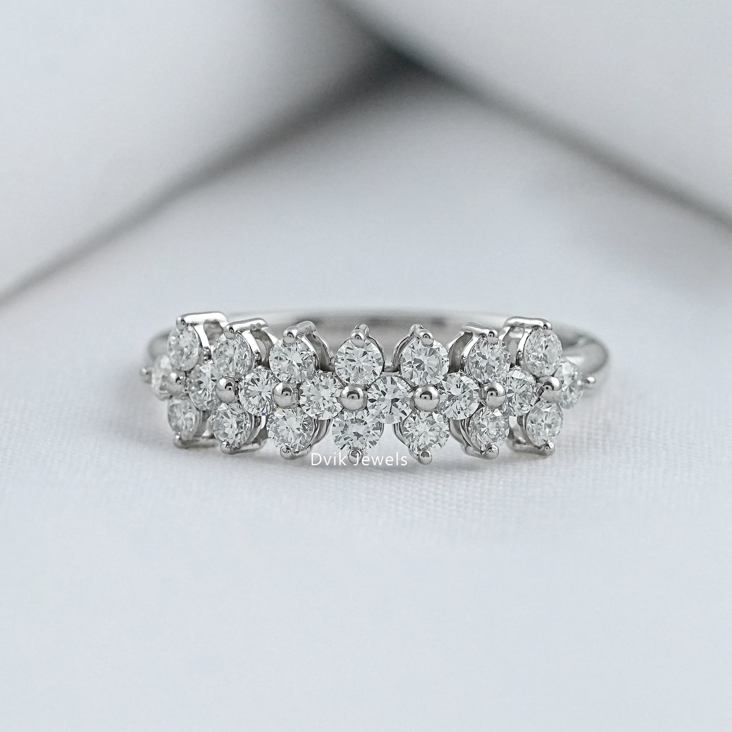 Front view of Dvik Jewels flower cluster rings featuring a central lab diamond and petal halo.