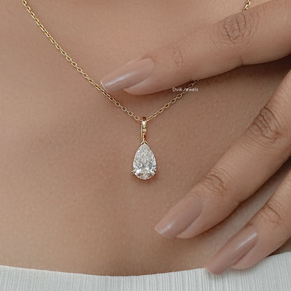 Solitaire pendant necklace with pear cut diamond on neck to show the relative scale and sparkle