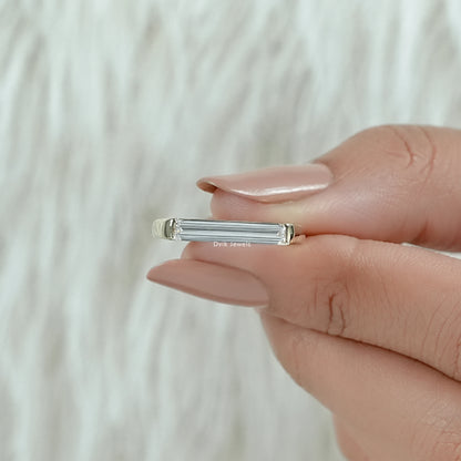 Baguette cut diamond solitaire ring with a sleek and polished design