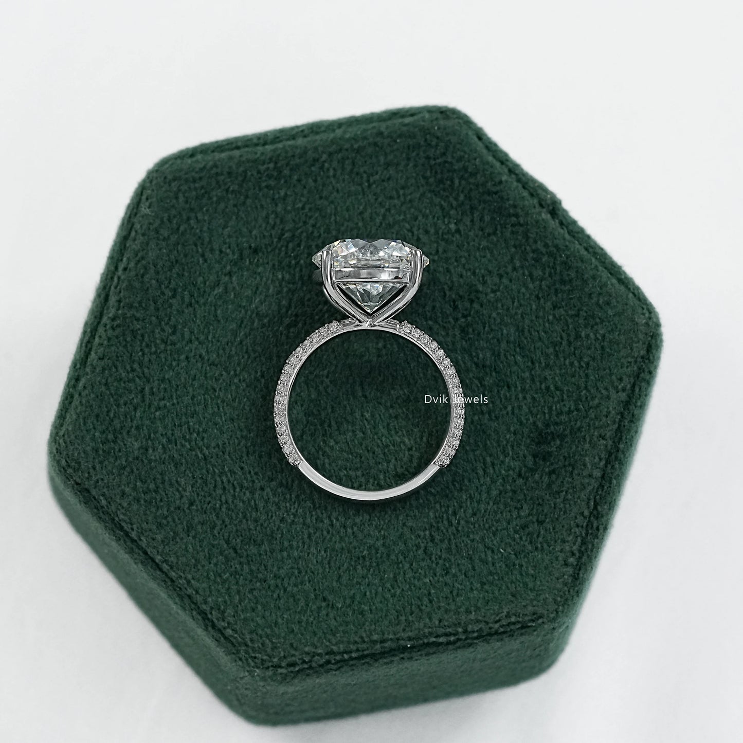 Round stone engagement ring with side stones and micro pave band side view