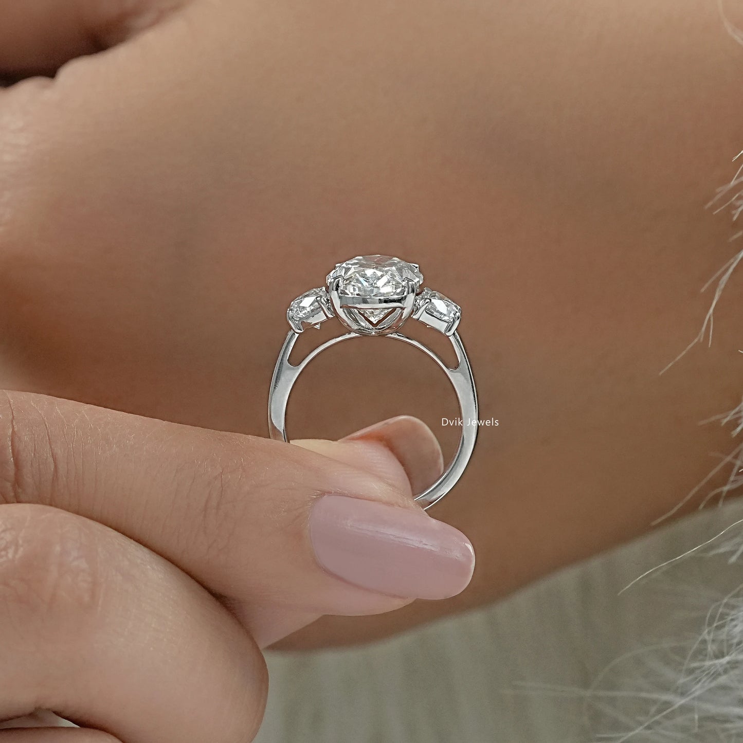 Oval half moon engagement ring worn on a hand showing the large center stone