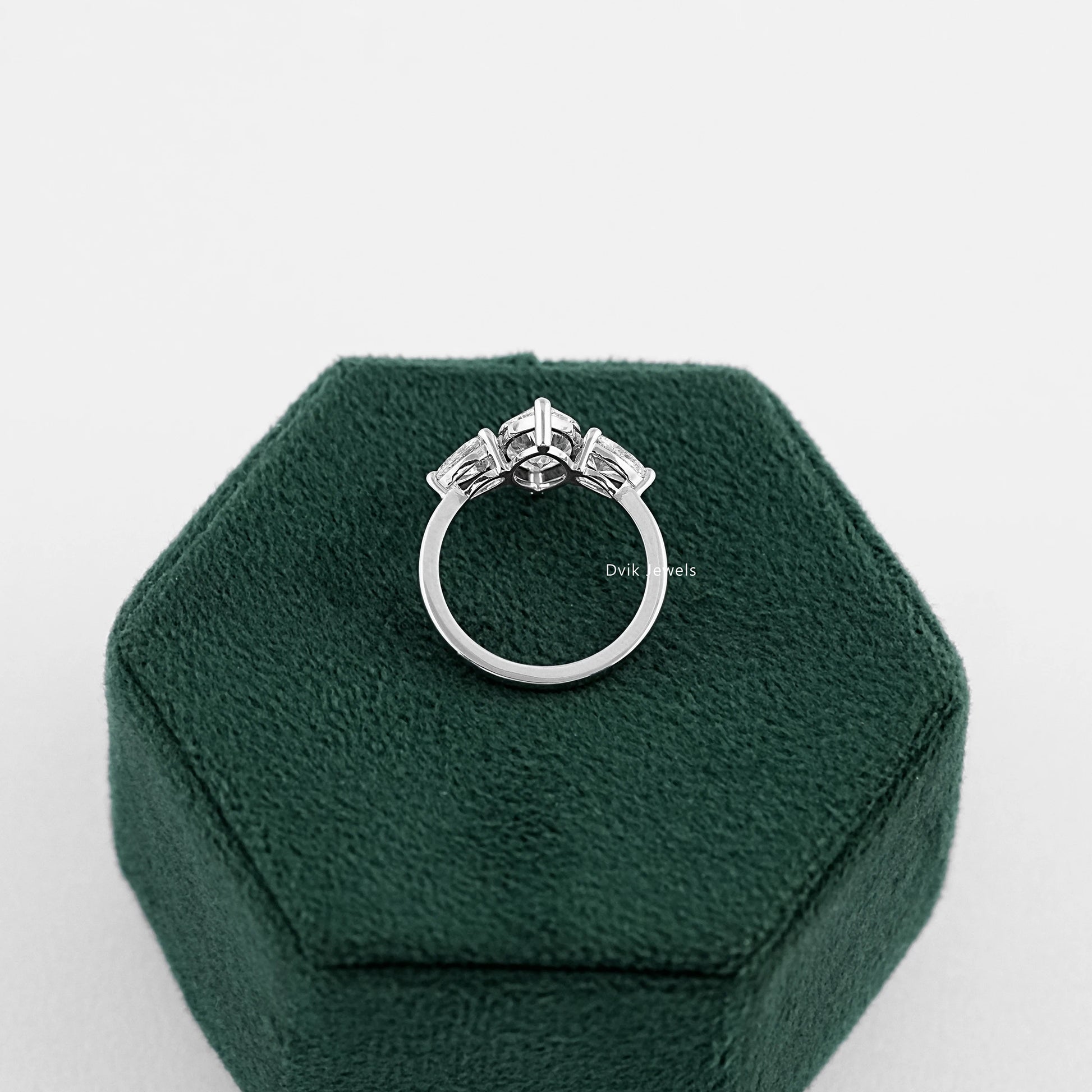Three Stone Marquise Cut Engagement Ring held on jewelry box showing back setting