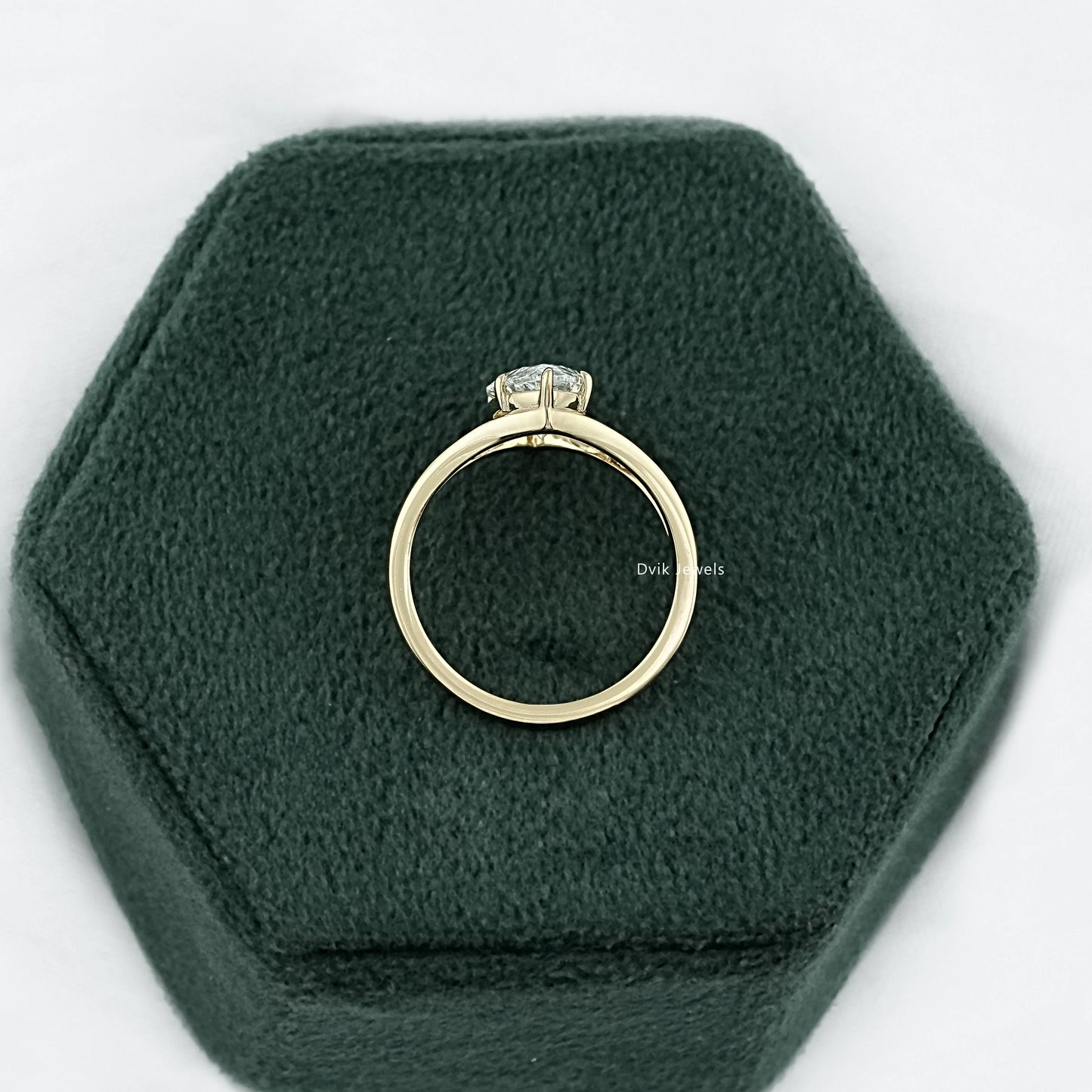 Marquise split shank ring displayed on a soft grey surface for a clean view.