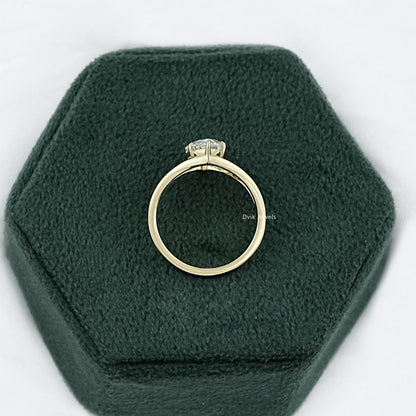 Marquise split shank ring displayed on a soft grey surface for a clean view.