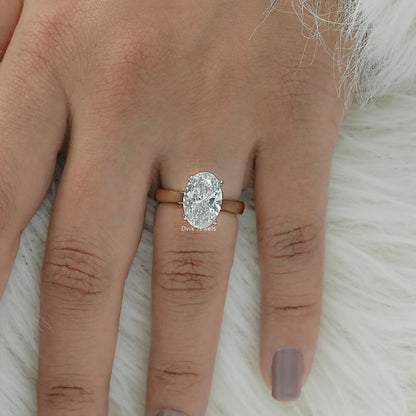 Top view of an oval solitaire engagement ring showing the classic slender band and metal work.