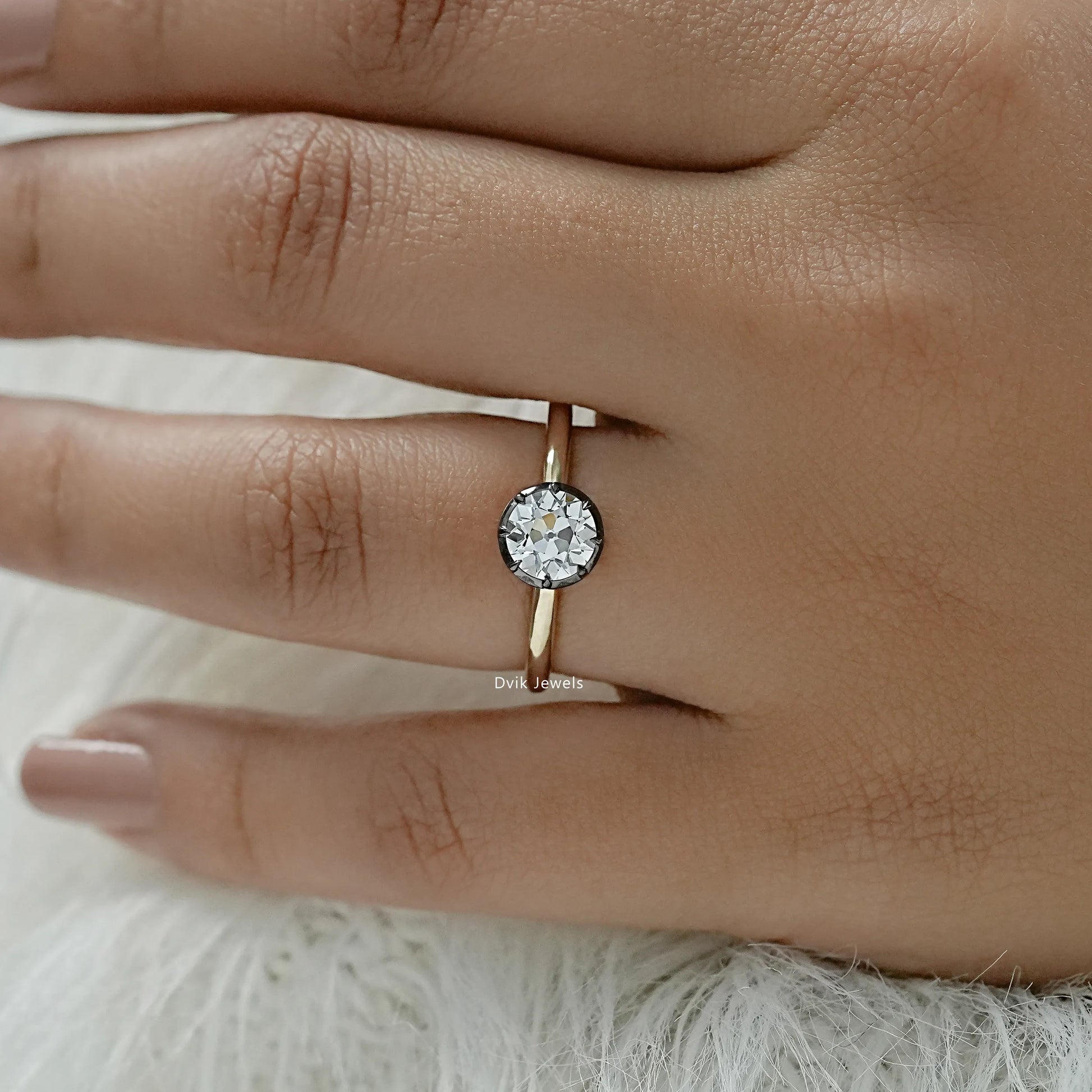 Round diamond bezel ring with a sleek and polished yellow gold band.