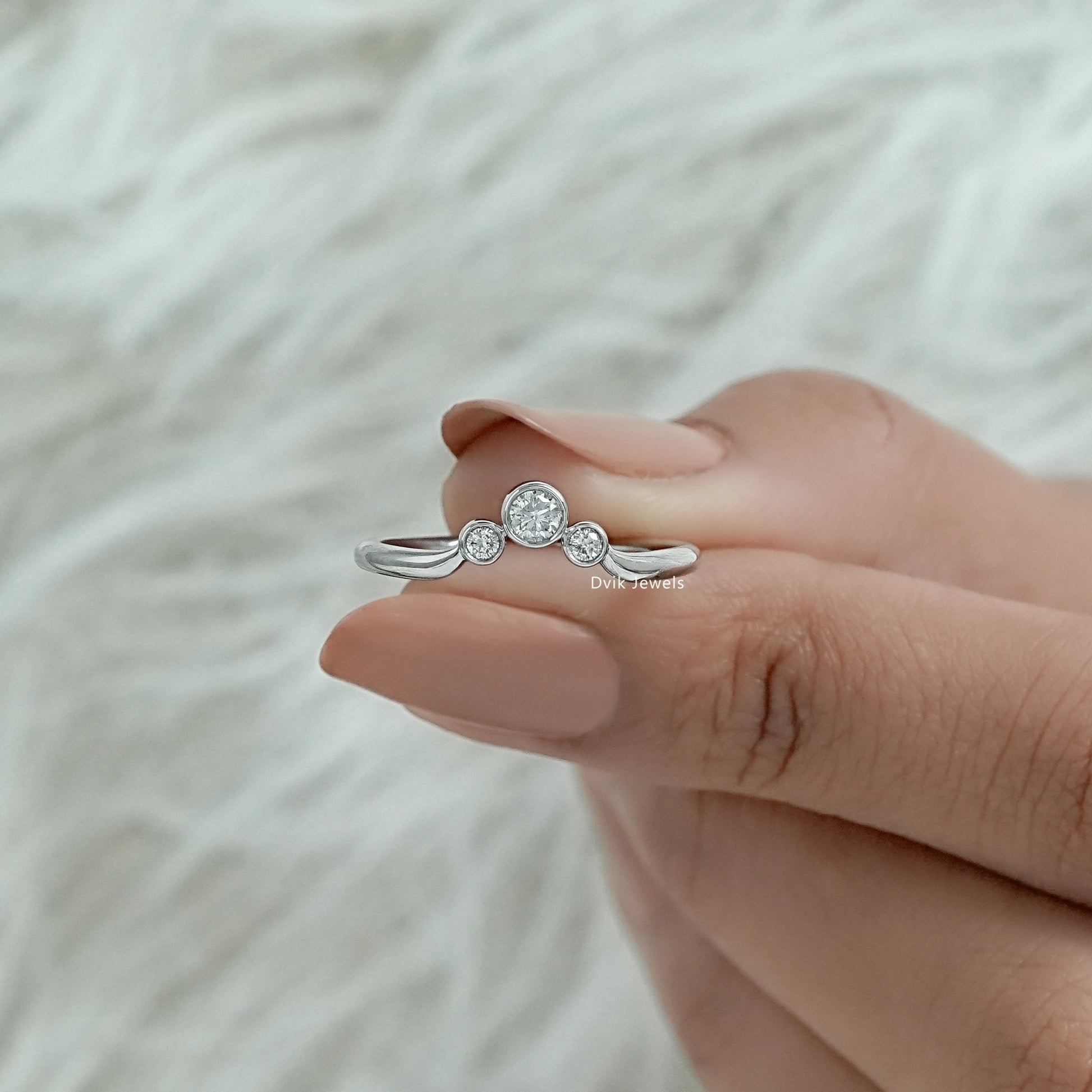 Lab diamond 3 stone ring with a sleek and polished yellow gold band.