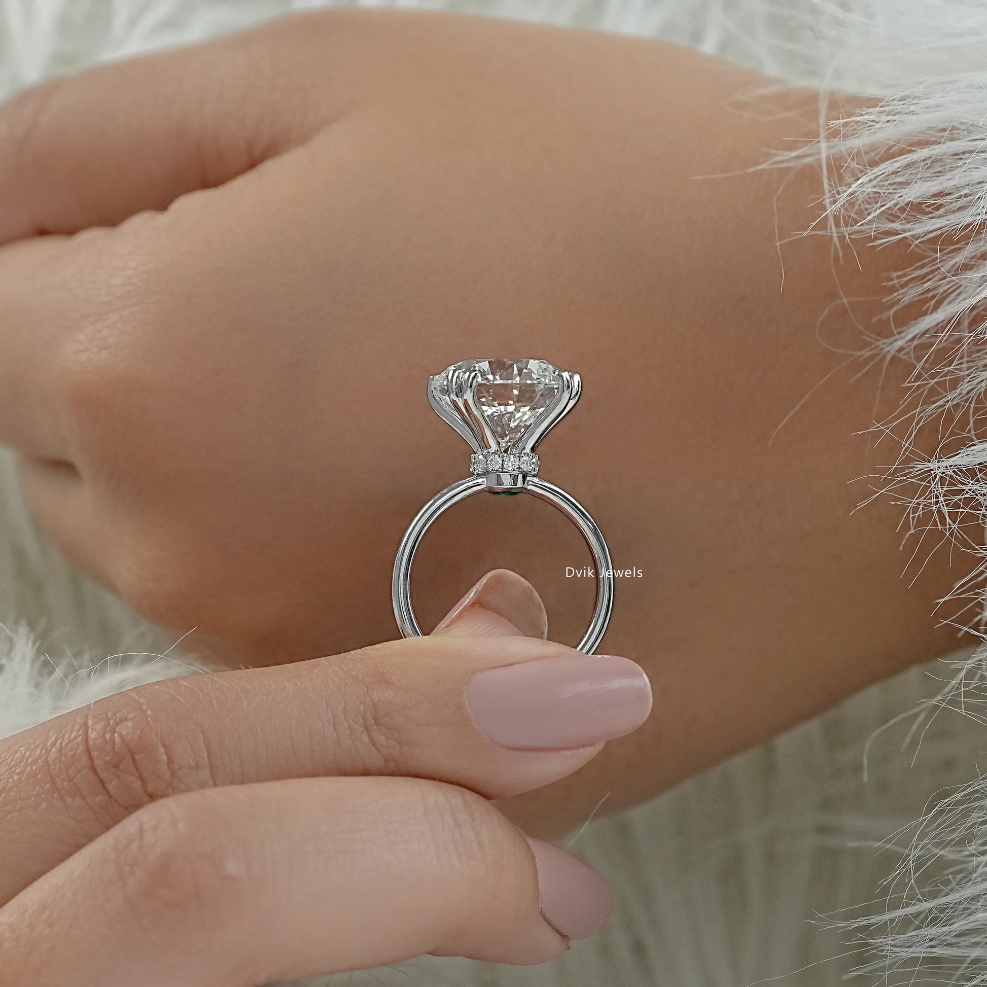 Solitaire ring with hidden halo and six prong round setting profile view