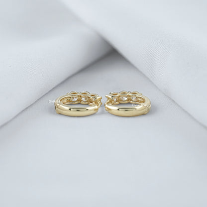 Back view of three stone huggie earrings with round cut diamond showing secure lock view