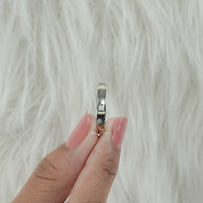 Twin pear cut lab diamond modern band with side view held by women