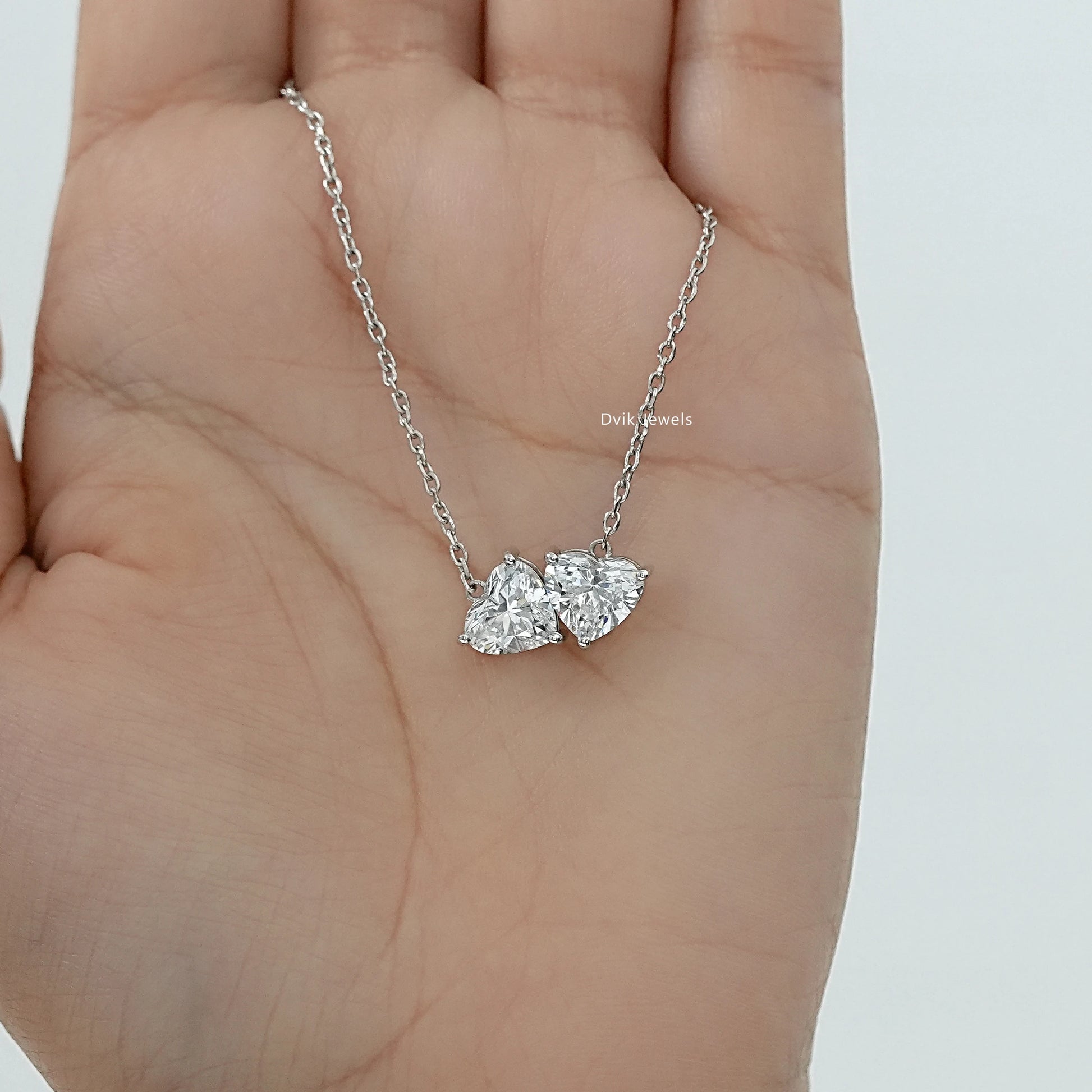 Two tone heart pendant with lab diamond hearts in silver setting