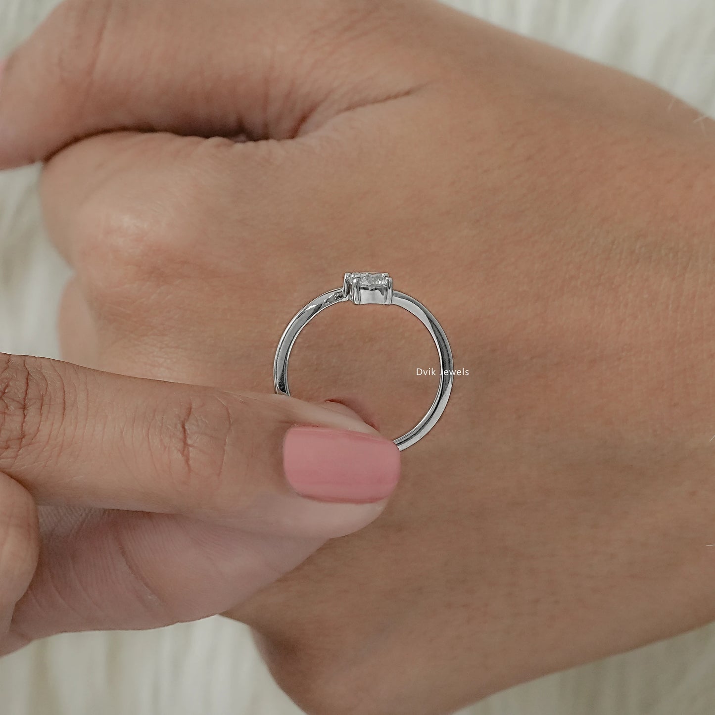 Twin stone lab diamond bypass ring held by women in white gold