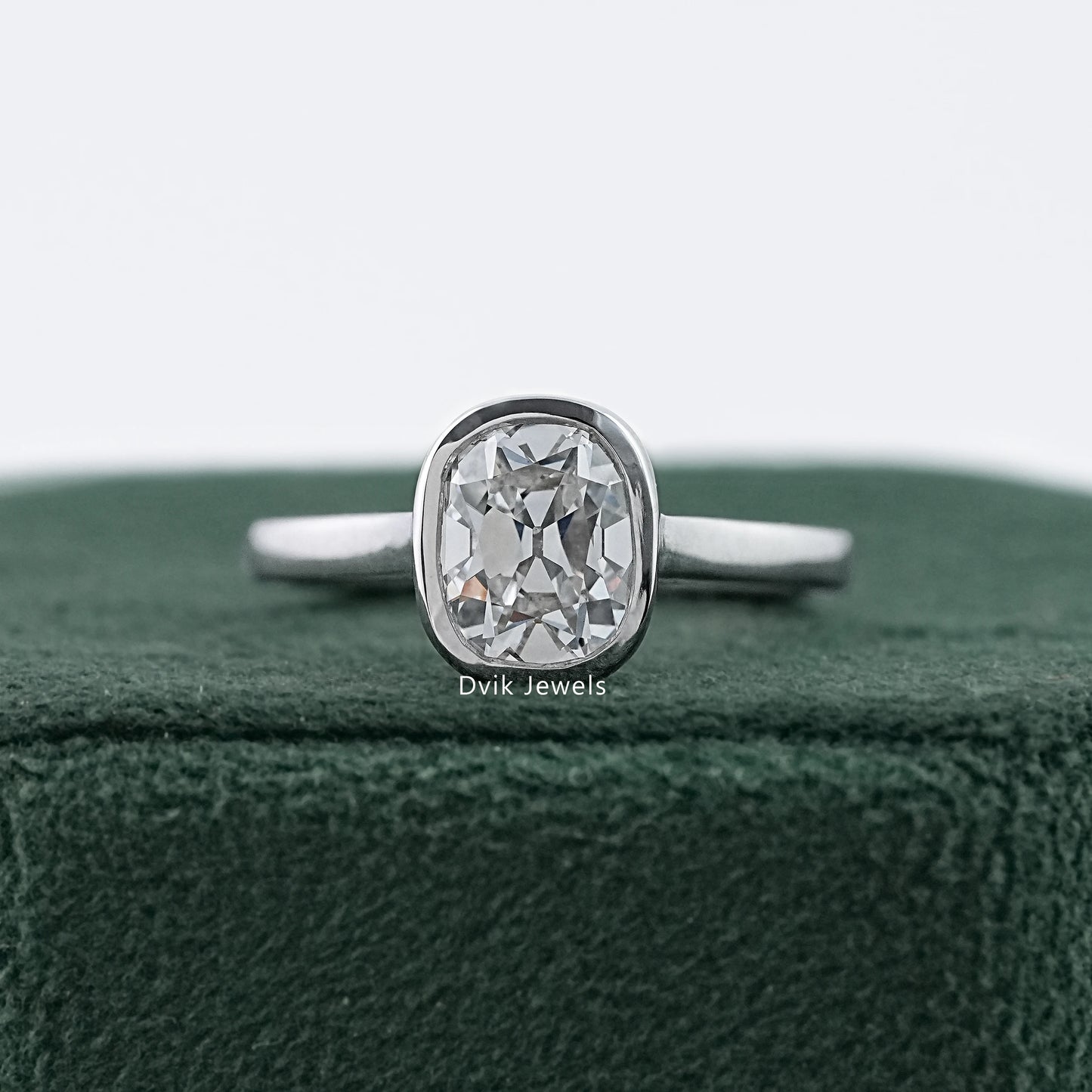 Old mine cushion cut bezel set diamond ring in white gold by Dvik Jewels