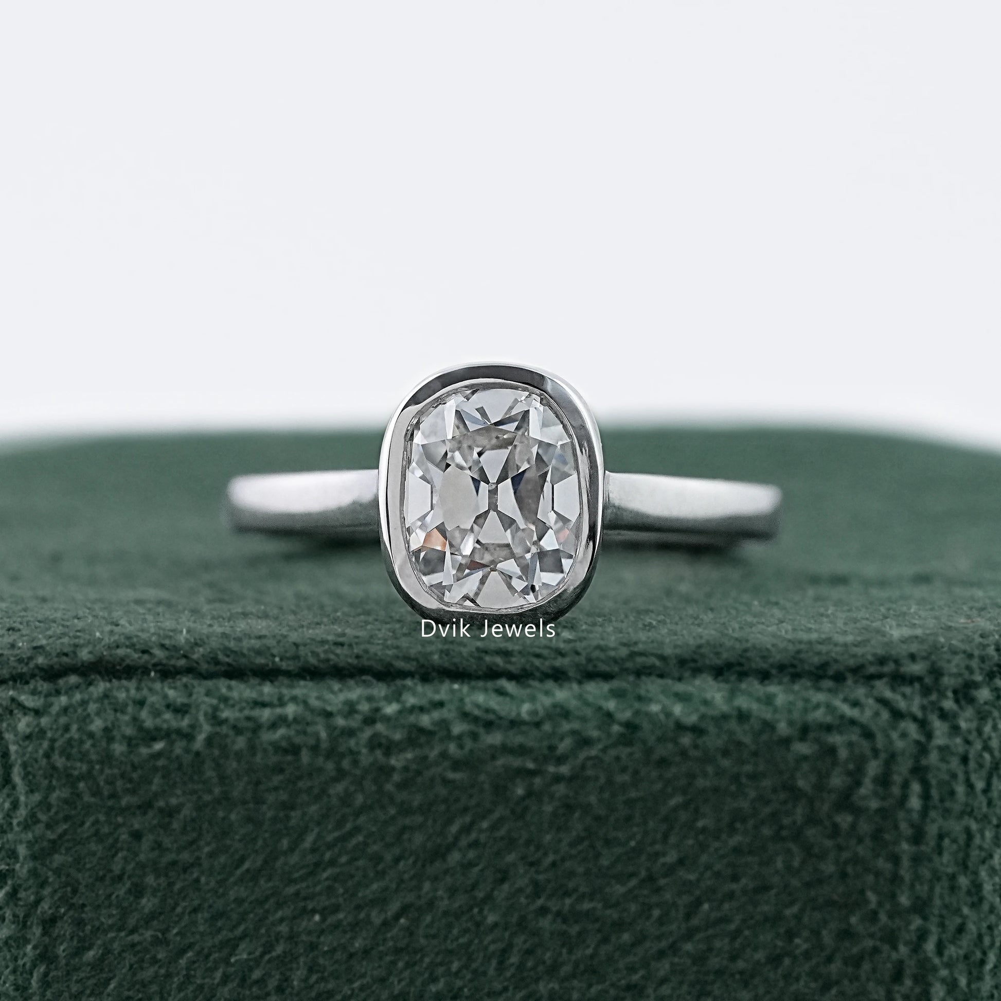 Old mine cushion cut bezel set diamond ring in white gold by Dvik Jewels