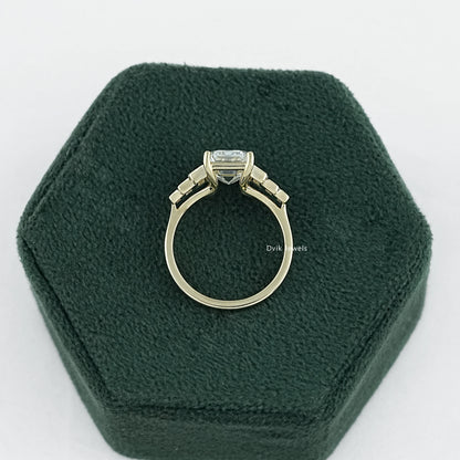 7 stone emerald cut diamond ring held to show the high quality metal band.