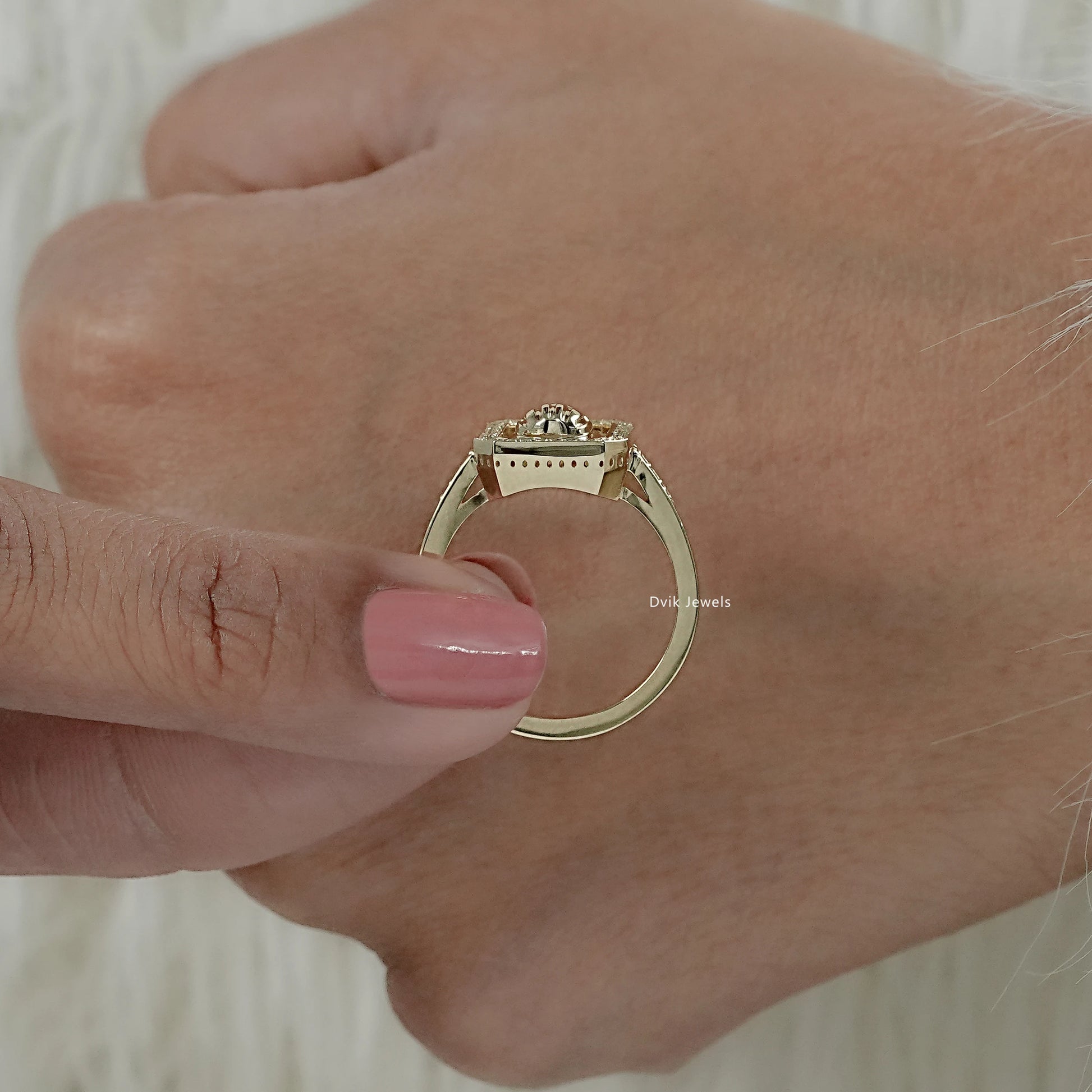 Vertical view of lab grown round diamond ring hold by women to show halo pave detailing