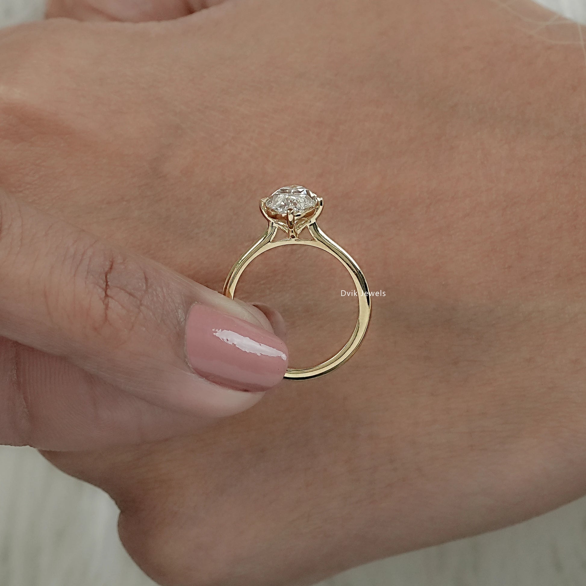 Moval shape solitaire engagement ring with lab grown diamond showing large chunky facets