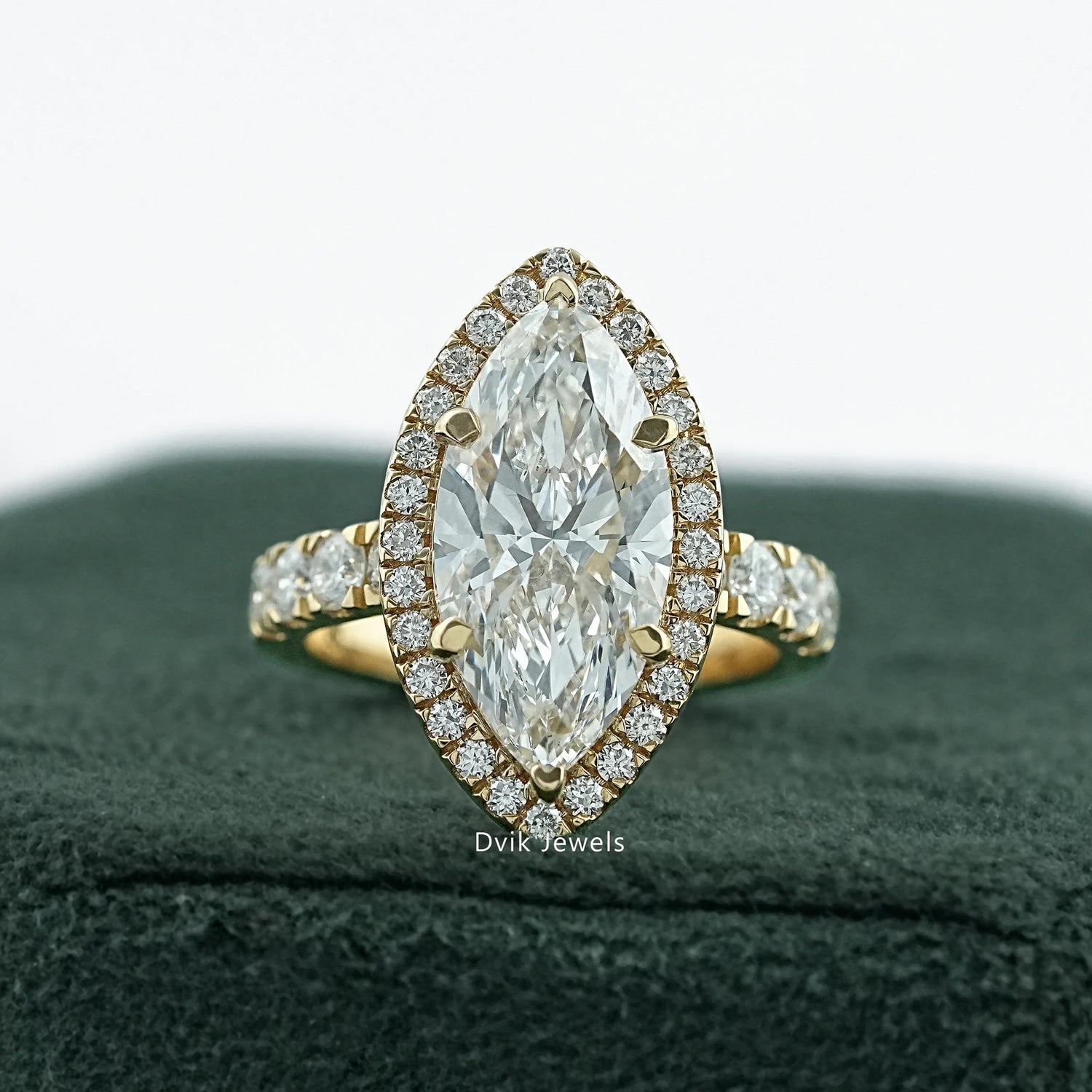 marquise halo engagement ring by Dvik Jewels in a green velvet box angle view
