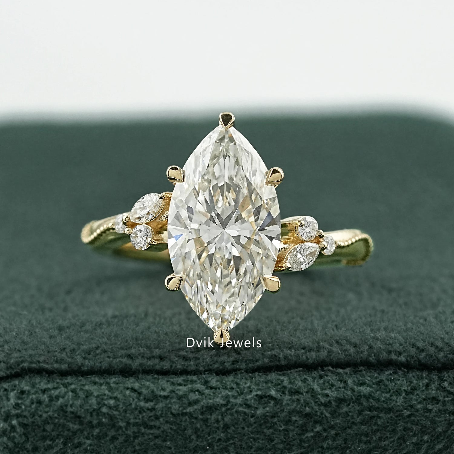 marquise Cluster Engagement Ring by Dvik Jewels in a green velvet box angle view