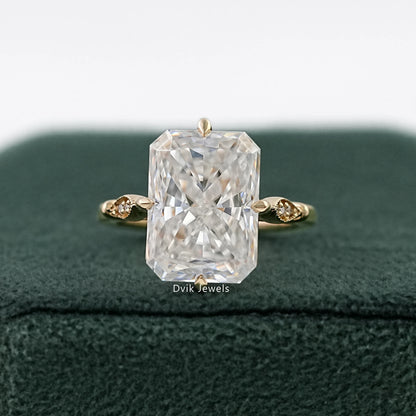 Radiant Cut Solitaire Ring in yellow gold on a green velvet box.